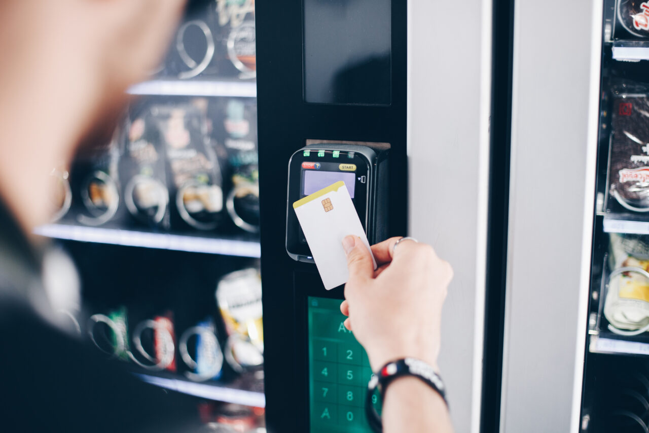 a person using the contactless payment method at a vending machine