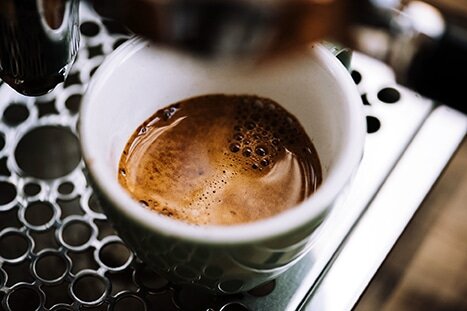 cup of fresh ground coffee from machine