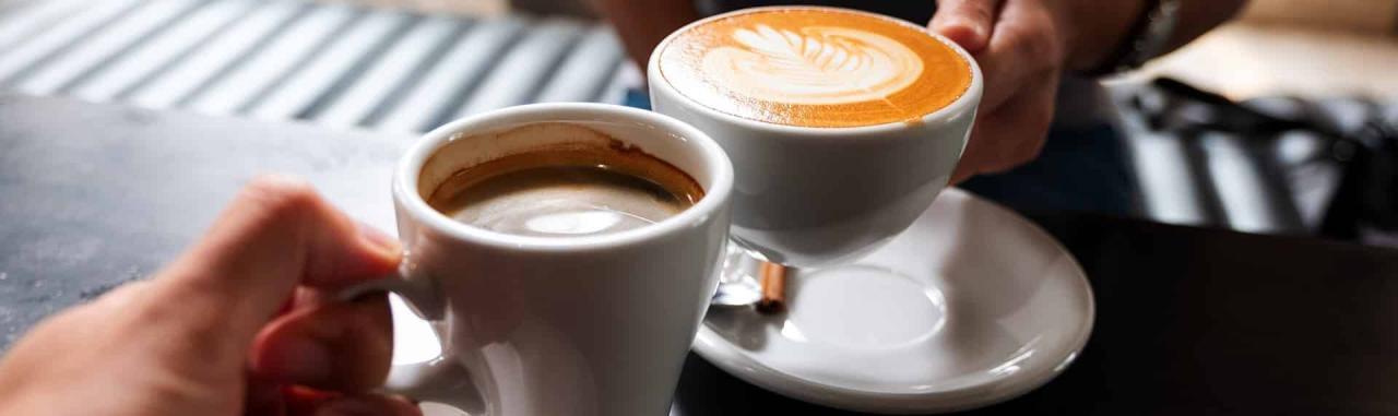Two people enjoy coffee in white cups