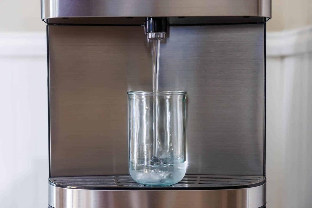 a water dispenser pours into a glass