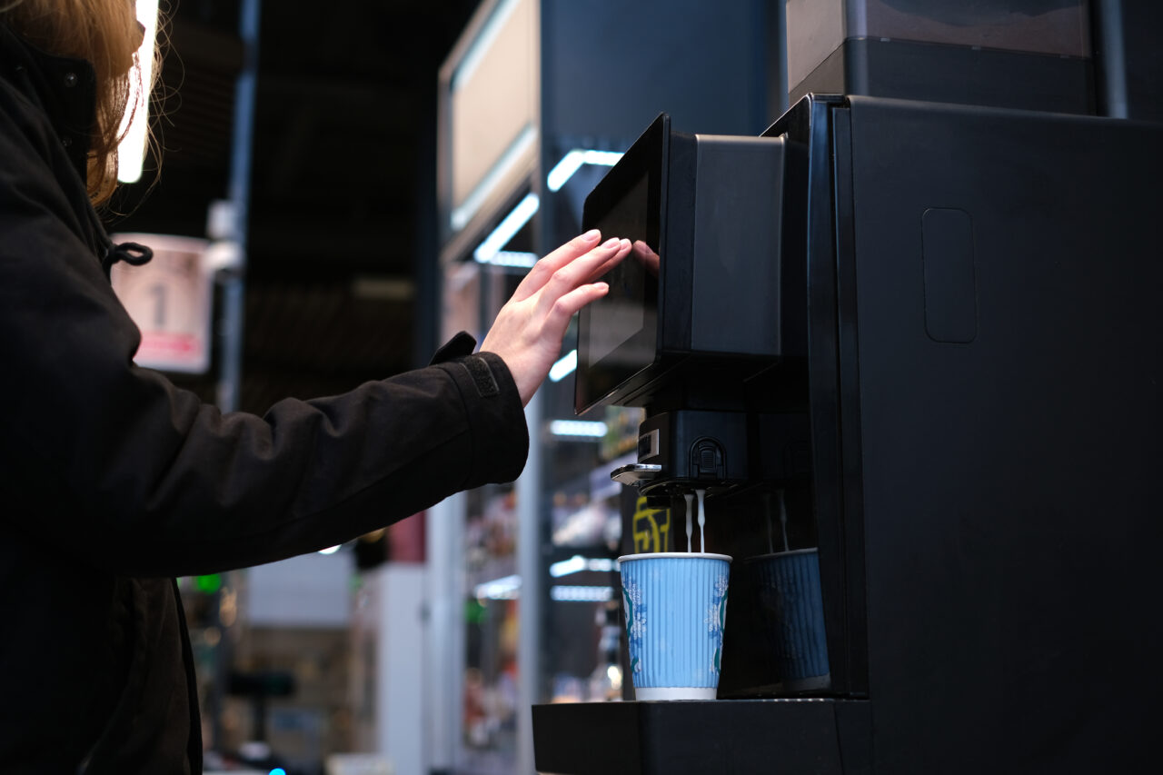 Man,Makes,Himself,Coffee,In,A,Self-service,Machine.,Cappuccino with a bean to cup coffee machine
