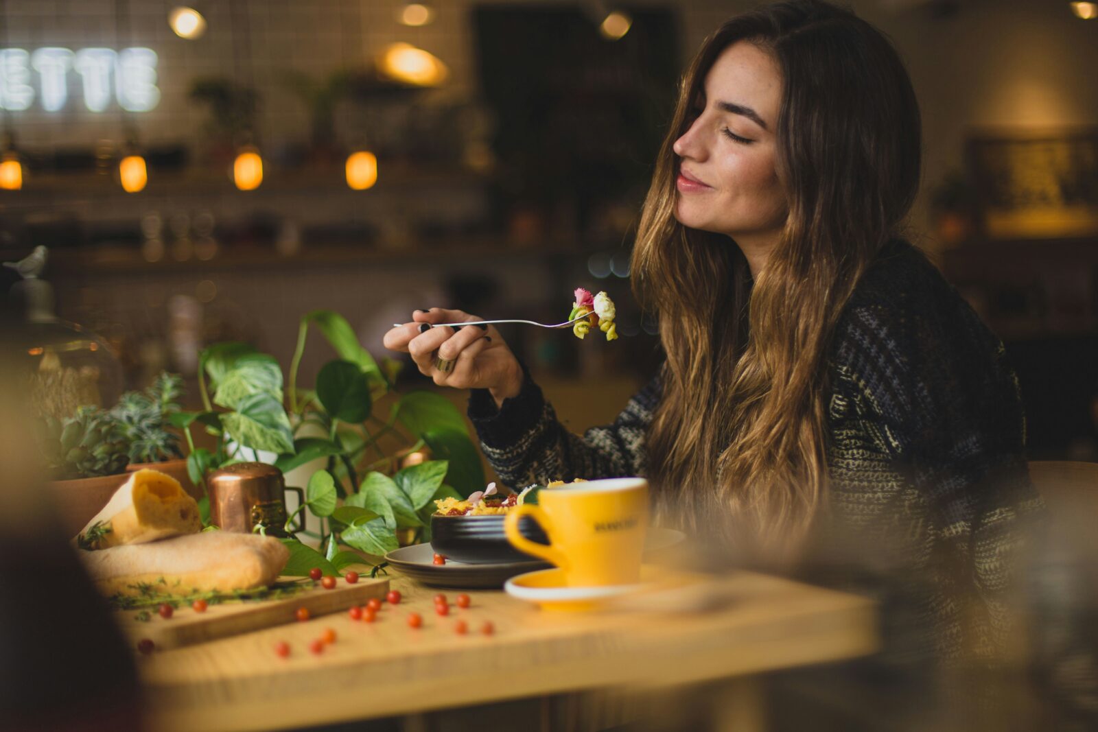 A vegan vegetarian woman eating lunch happily
