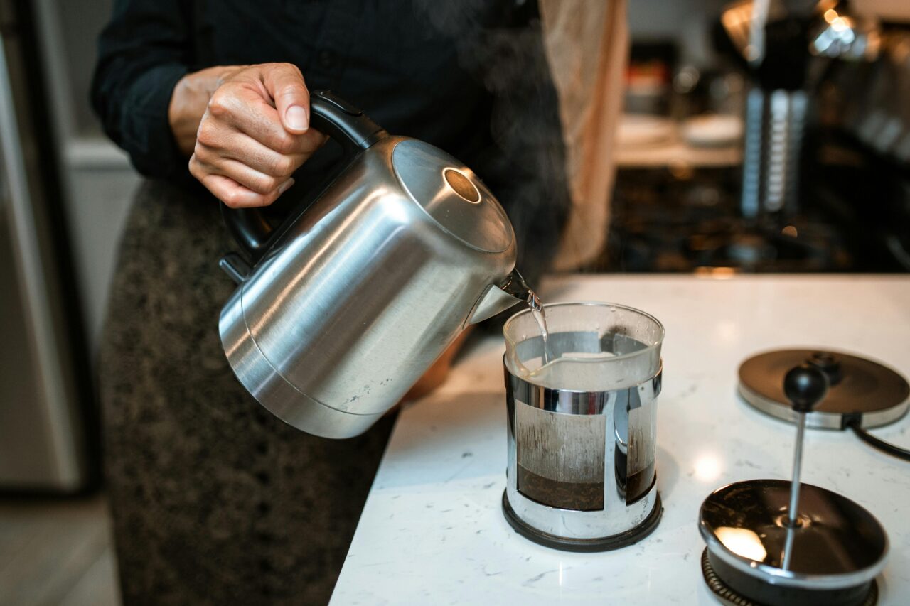 boiling water and preparing the hot water for mixing with the coffee grounds