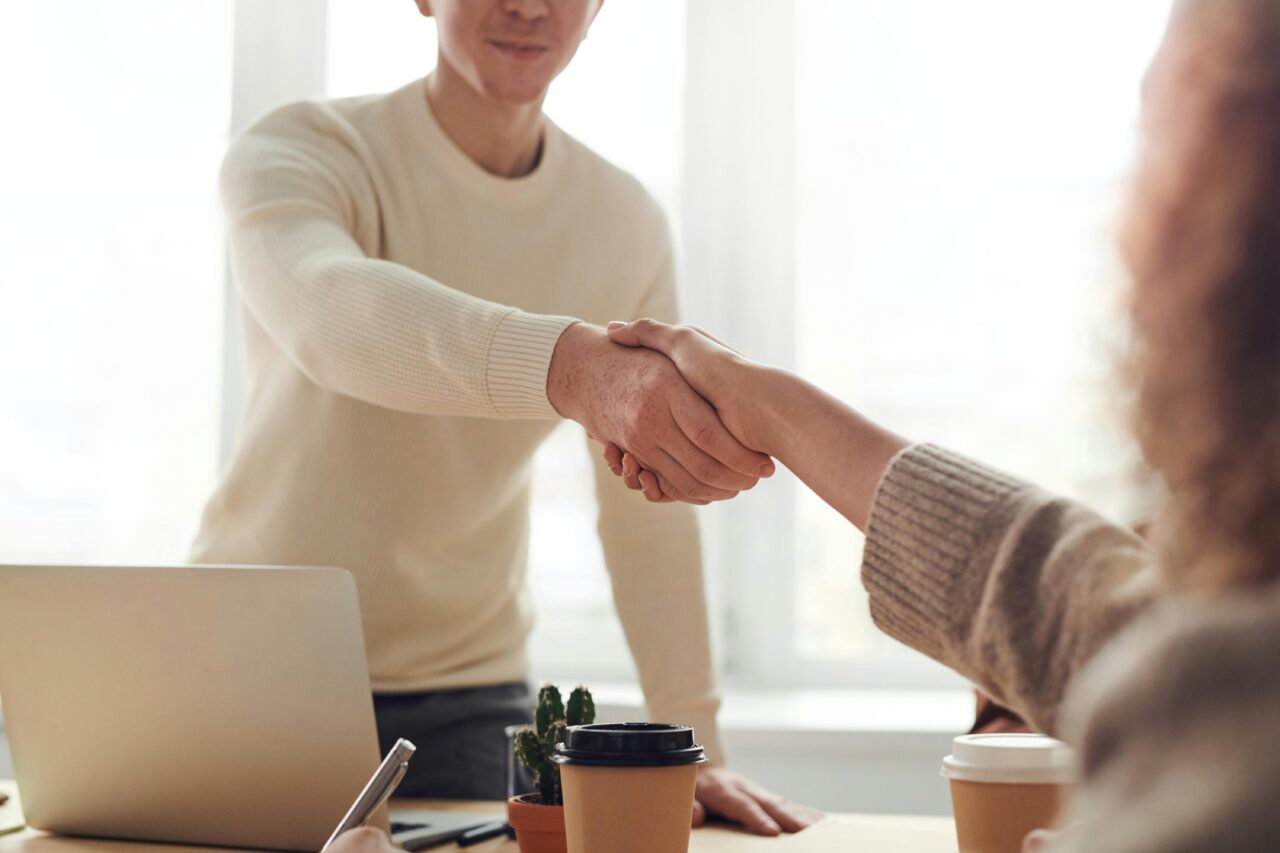 people shaking hands after agreeing to a vending machine service plan