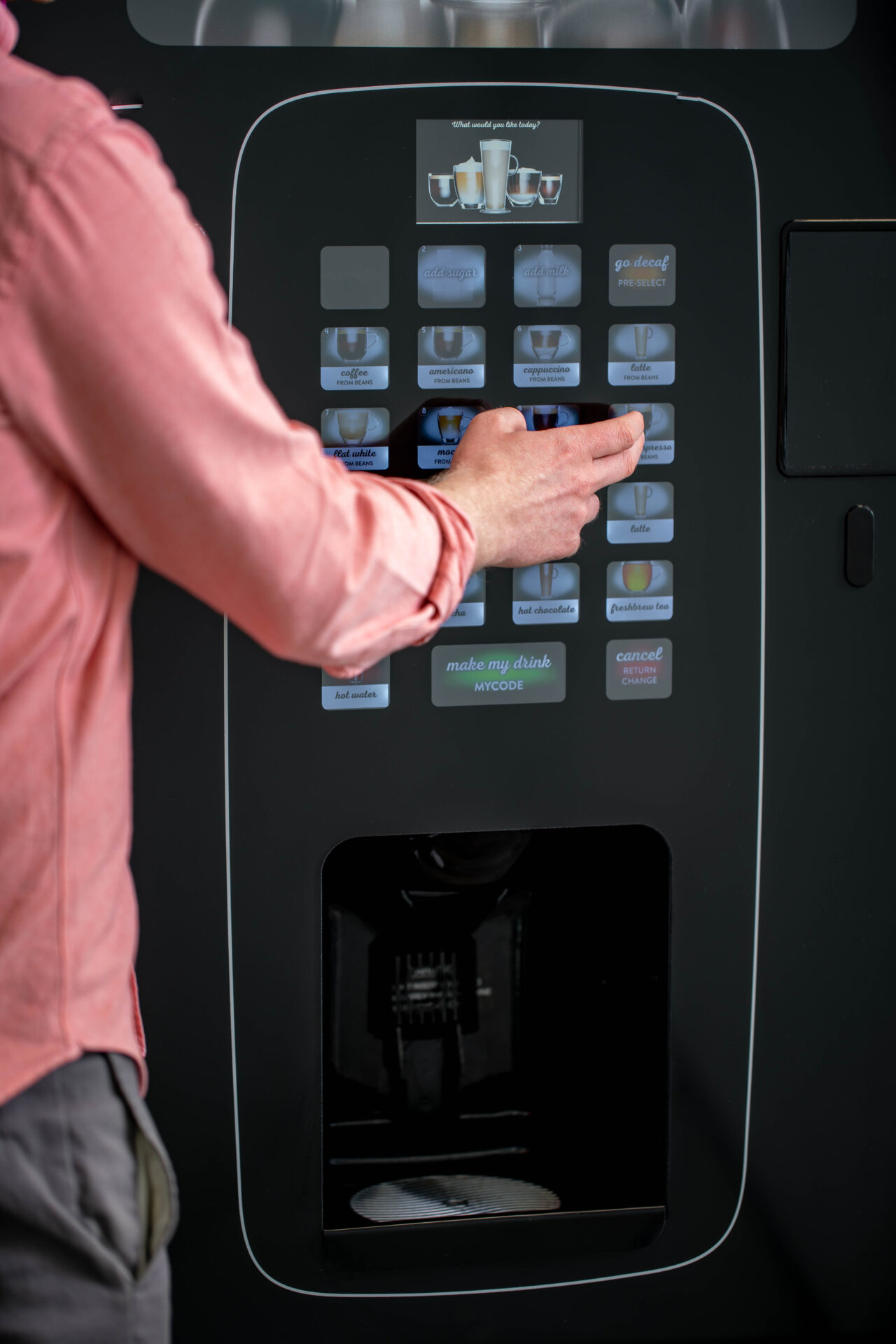 lady using an office coffee machine