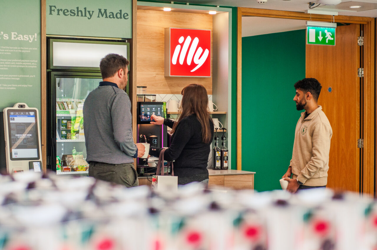 People using a commercial coffee machine