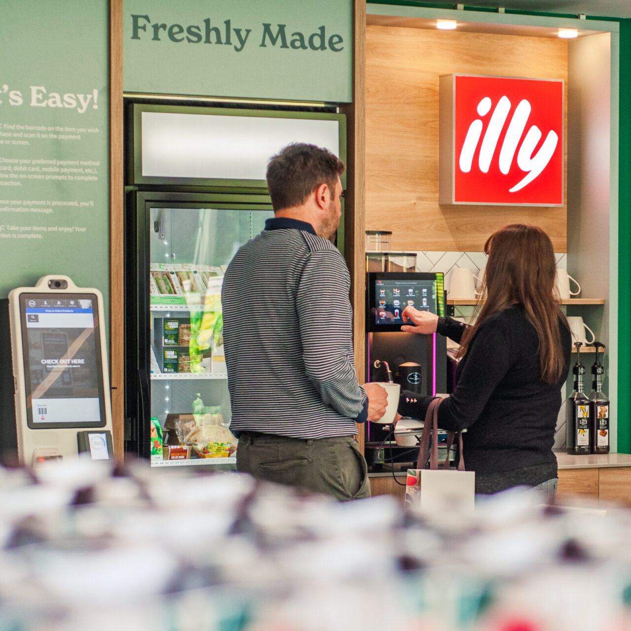 People using a commercial coffee machine