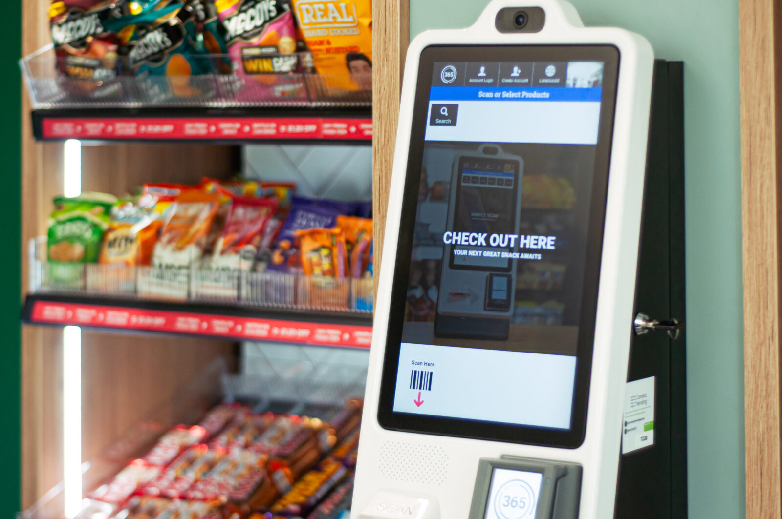 An ambient bay containing crisps and snacks behind a self-service till