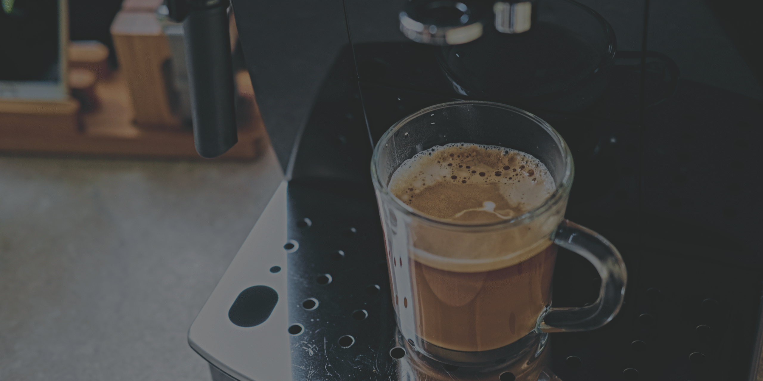 A cup of coffee made by a commercial coffee machine