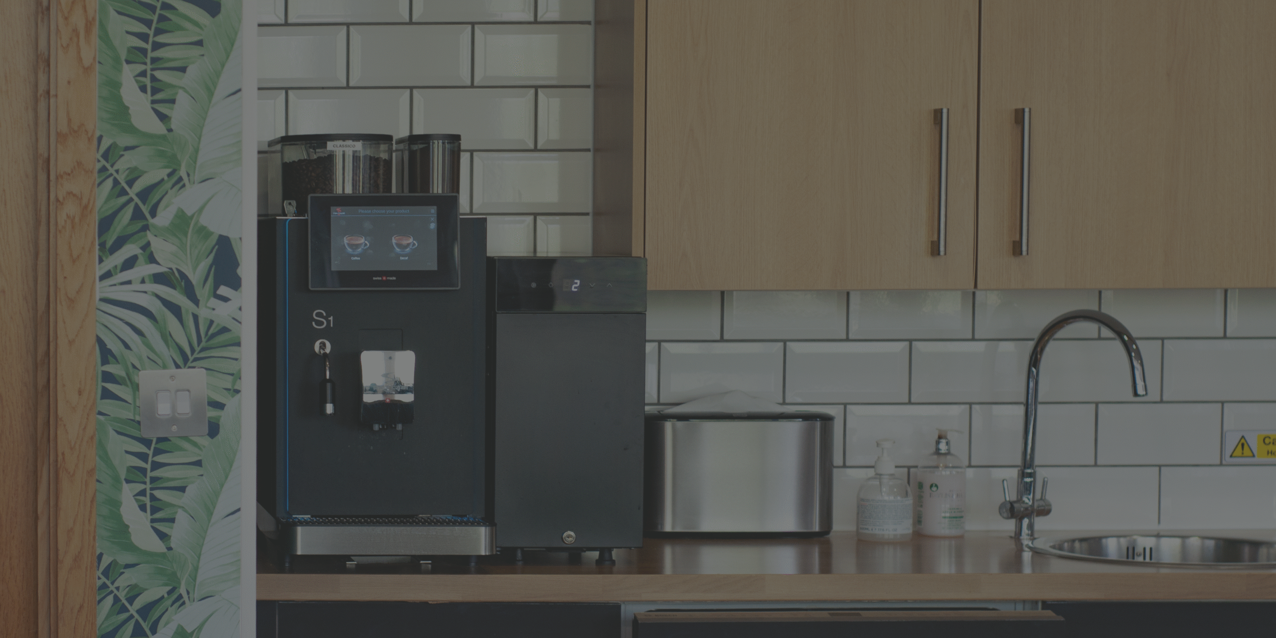 A fresh milk table-top coffee machine with modular fridge attachment.